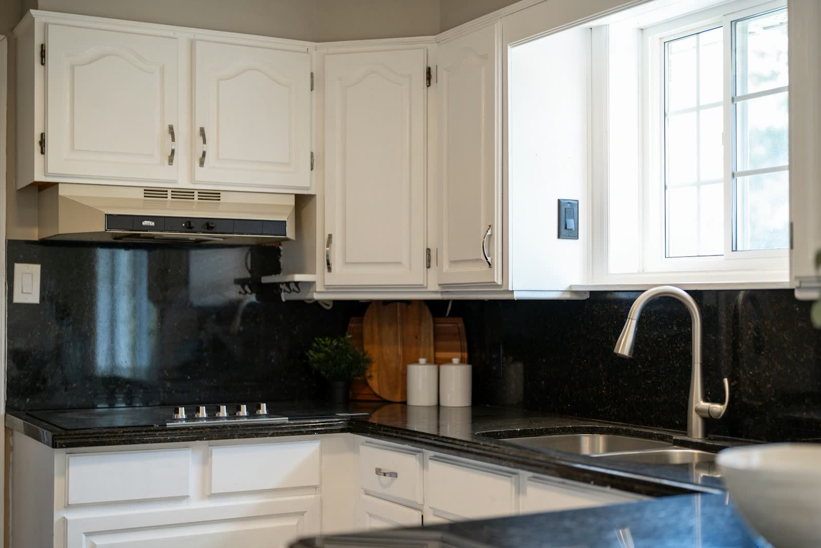 White kitchen with black countertops