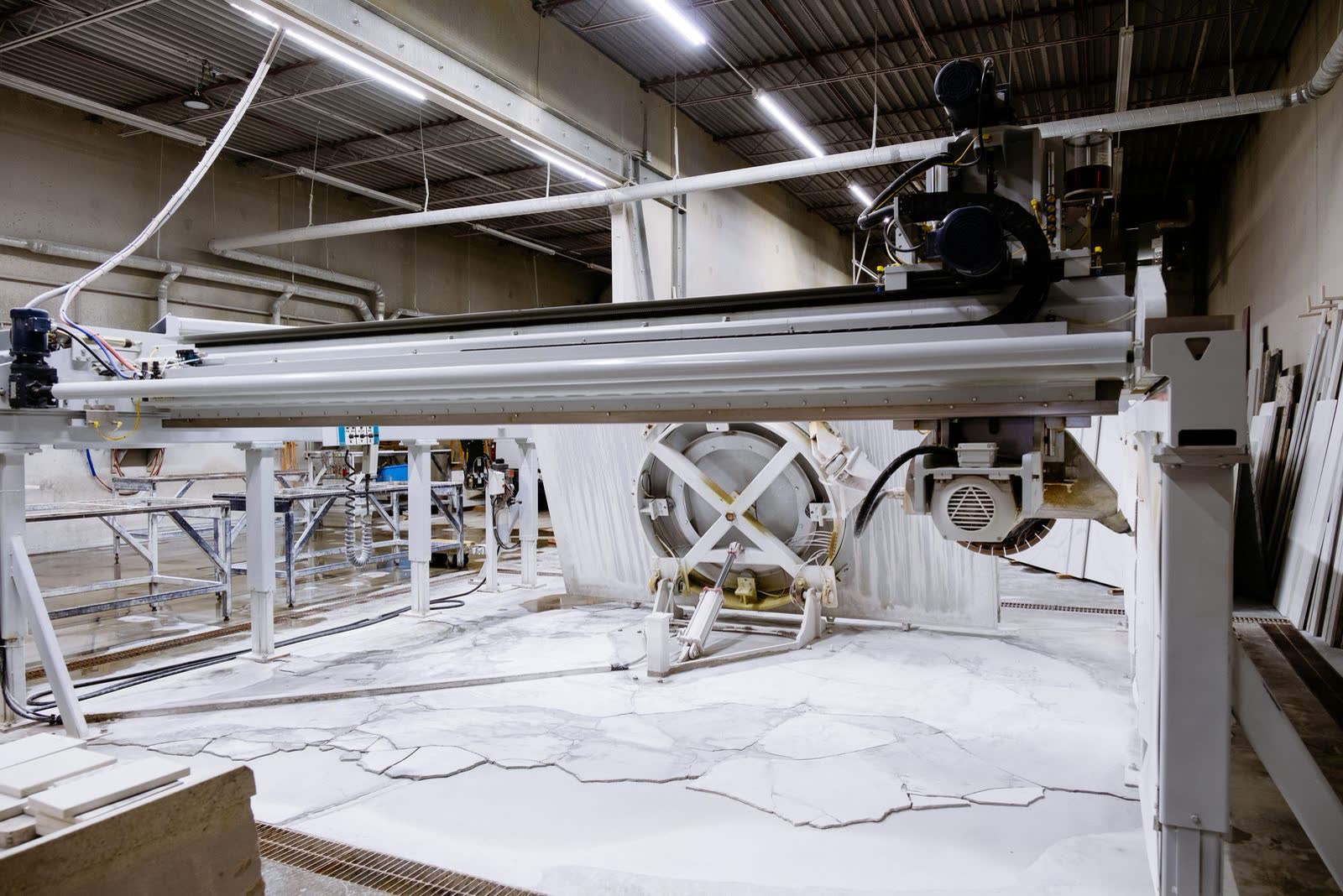 Granite slabs being cut on a bridge saw